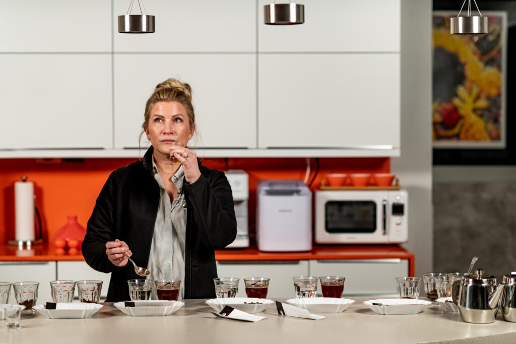 Karen cupping coffee samples during a COROCO tasting and quality review