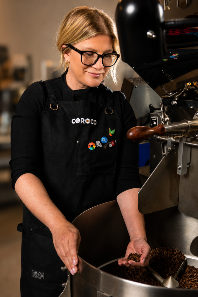 Karen Weckerly roasting coffee beside the COROCO coffee roaster.