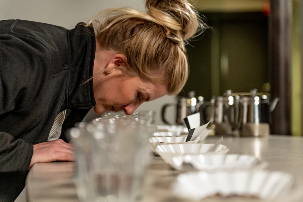 Karen Weckerly evaluating coffee aroma during a cupping at COROCO Coffee.